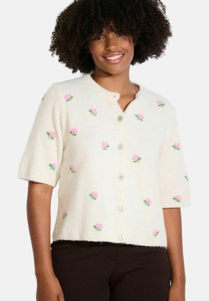 Cream-colored short-sleeve cardigan with pink flower embroideries and green accents, featuring a button-down front and soft, textured fabric.