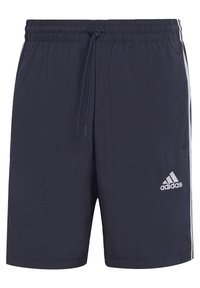 Marinfärgade simshorts i lätt material med elastisk midja och dragsko. Har vita sidovolanger och en Adidas-logga på framsidan.