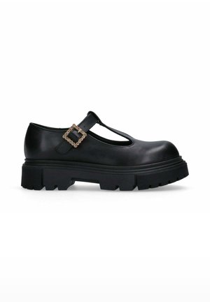 Scarpa Mary Jane nera in pelle con suola chunky, design a T-strap e una fibbia quadrata decorativa con un accento di strass.