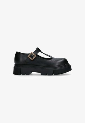 Scarpa Mary Jane nera in pelle con suola chunky, design a T-strap e una fibbia quadrata decorativa con un accento di strass.