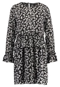 Musta kukallinen mekko pitkillä hihoilla, röyhelöillä hihoissa ja kerroksellisella muotoilulla. Sisältää valkoisia kukkakuoseja läpikuultavassa kankaassa. Takana napitus.