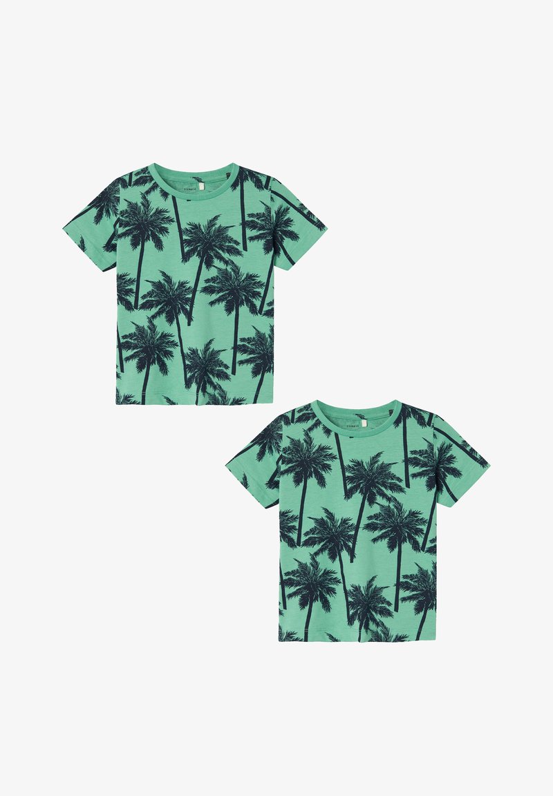 Green fabric t-shirt featuring a black palm tree print, short sleeves, and a round neckline. Suitable for casual wear.