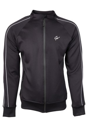 Zwarte zip-up jas van gladde stof, met witte zijkanten, een hoge kraag en ritszakken. Versierd met een logo op de borst.