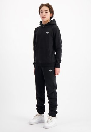 CRUISE - Tracksuit bottoms - black