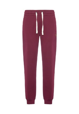 Pantaloni della tuta color bordeaux realizzati in morbido misto cotone, con vita regolabile tramite coulisse, polsini a coste e un piccolo logo dorato di lato.