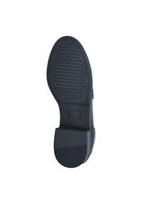 Black rubber shoe sole with textured grip, featuring a slight heel and a smooth surface. Square and curved edges define the overall shape.