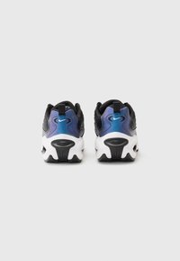 Black and blue Nike sneakers with a textured upper, featuring a gradient at the heel, a white midsole, and black rubber outsole.