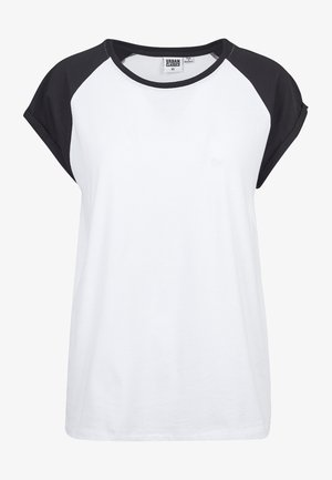 Biała koszulka z krótkim rękawem z czarnymi rękawami raglanowymi. Miękka bawełniana tkanina, okrągły dekolt, luźny fason i minimalne oznakowanie na metce.