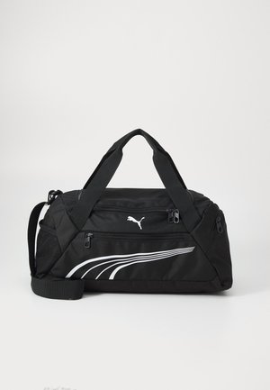 Svart sportveske med teksturert stoff, med en fremtredende hvit Puma-logo og bølgende hvite striper foran. Justerbar skulderrem.