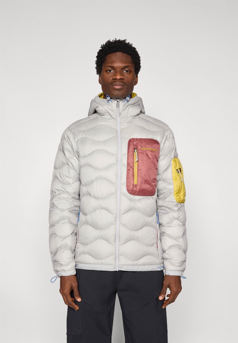 Jasnoszara pikowana kurtka z kapturem, z różowymi i żółtymi kieszeniami, niebieskimi akcentami i fakturowanym wykończeniem. Zapięcie na zamek błyskawiczny z przodu.