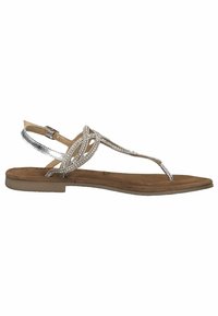 Zilveren versierde platte sandalen met een enkele tepost, een ingewikkeld ontwerp van banden en een lichtbruine suède voetbed. Minimalistische rechthoekige zool.