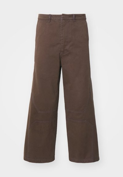 Brown wide-leg trousers made of durable cotton. Features front patch pockets and reinforced knee details for added functionality.