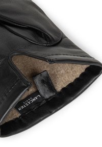Black leather glove with a soft felt lining; features a smooth texture, elastic cuff, and a woven label with "LANCASTER PARIS" text.
