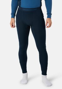 Leggings thermiques marins avec une texture côtelée et une taille élastique arborant le logo "SWEDEMOUNT". Coupe ajustée, tissu lisse et couvrance pleine longueur.