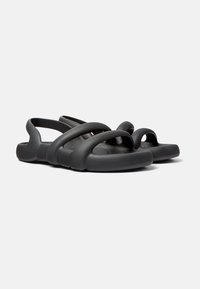 Black rubber sandals featuring a multi-strap design, smooth texture, and a rounded toe shape, with open sides for breathability.