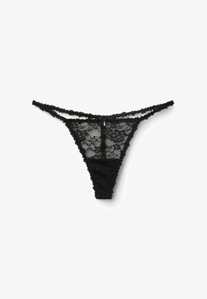 String en dentelle noire avec motif floral, fine taille double, petit nœud et breloque décorative au centre devant.