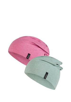 Two soft slouchy beanies, one pink and one light green, each with a small black brand tag sewn on the front.