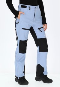 Light blue and black snow pants with zippered pockets and adjustable waist. Made of durable fabric, featuring contrasting color panels and a sleek design.