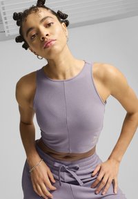 Paarse geribde tanktop met een cropped ontwerp, voorzien van een ronde hals en subtiele logo-detail. Glad textuur, gecombineerd met bijpassende onderkleding.