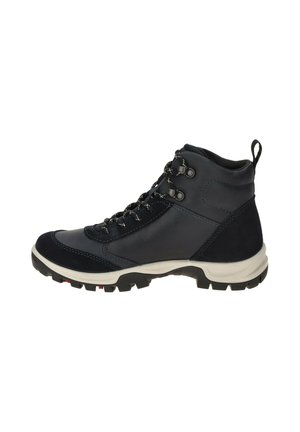 Black and gray hiking boot with thick white sole, black and white laces, metal eyelets, and pull tab on the ankle collar, side view.