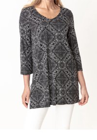 Svart tunika med V-ringning och trekvartsärmar, med ett vitt geometriskt mönster och en lös, flödande passform.