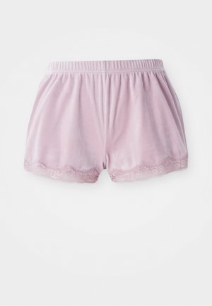Bermudas de veludo cor-de-rosa com um cós elástico e rendinha na bainha, posicionadas contra um fundo branco liso.
