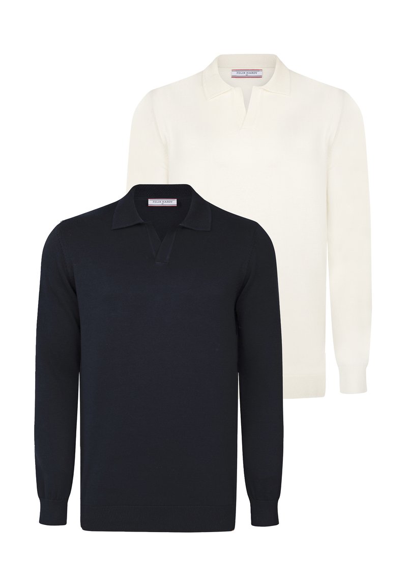 Kaks pikakäiste poloeme: üks tumesinisest ja teine kreemjast. Mõlemal on klassikaline krae ja soonikuga mansetid, valmistatud pehmest koekangast.