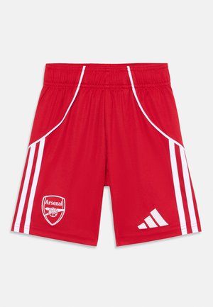 Piros sportnadrág fehér oldalsávokkal. Bal lábszáron Arsenal logo, jobb alsó szegélyen Adidas logo található.