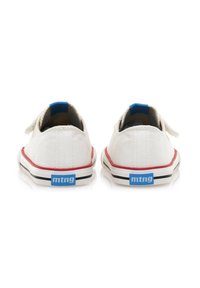 Zapatillas de lona blancas con acentos rojos, suela de goma negra y blanca, talón azul y logotipo en la parte posterior. Cierre con correa de velcro.