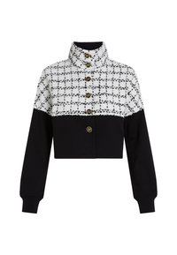 Cropped jacket featuring a white and black checkered texture on the upper half and solid black fabric on the lower half. Four gold buttons adorn the front.