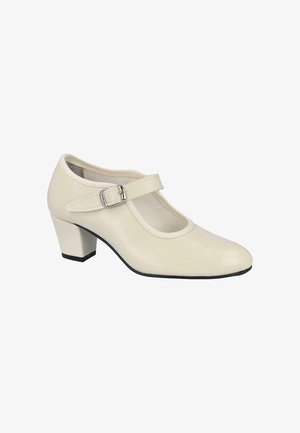 Zapato Mary Jane de cuero color crema con un tacón de bloque de altura media y una hebilla plateada en la parte superior del pie.