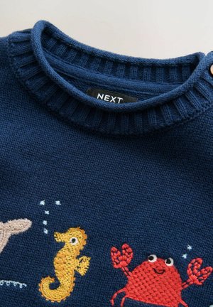 Navy knitted sweater with ribbed collar, featuring embroidered sea creatures: a seahorse, a crab, and a fish, in yellow, red, and beige.