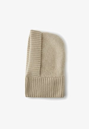 Beige mössa i ull med en texturerad, luddig topp och en ribbad mudd. Har en kontrastsömsdetalj på sidan. Mjukt och varmt material.