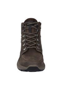 Bota marrón impermeable con un cuello acolchado, suela de goma y ojales de metal. Cordones con estampado y costuras reforzadas en el exterior.