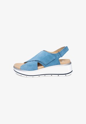 Blue suede open-toe sandal with adjustable strap, cushioned footbed, and white platform sole with black detailing.