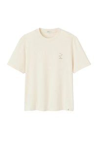T-shirt crème à manches courtes en coton doux. Présente un petit graphique d'un oiseau dans un design minimaliste sur le côté gauche de la poitrine.