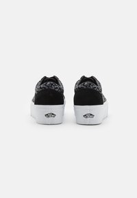 Black skate shoes with soft suede upper, textured fabric overlays, thick white platform sole, and logo detailing on the heel.