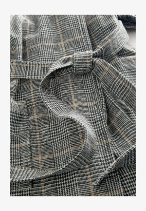 Plaid fabric in gray, black, and beige. Soft texture with a tied belt detail. Includes houndstooth and check patterns for visual interest.