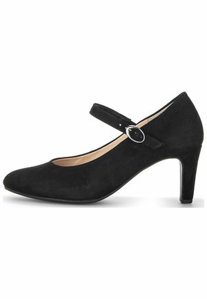 Zapato Mary Jane de ante negro con puntera redondeada, una correa delgada en el tobillo y un tacón alto y delgado. Textura suave y detalle de hardware minimalista.
