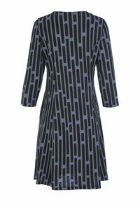 Sininen mekko, jossa on mustia pystysuoria pyöreitä suorakulmioita, kolmannelta neljännekseltä hihat ja A-linjainen leikkaus, nähtynä takaa.