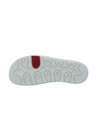 White rubber shoe sole featuring a textured pattern with grooves and a red accent near the center.