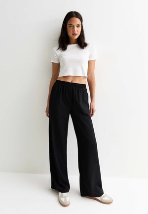 CUFFED - Tracksuit bottoms - black