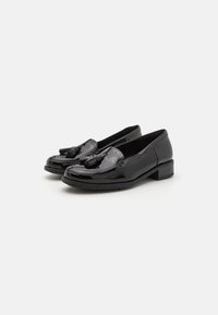 Black patent leather loafers with a rounded toe, a tassel accent, and a low block heel. Smooth texture and glossy finish.