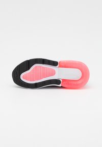 Black and pink athletic shoe sole featuring a textured black rubber platform, a white midsection, and a bright pink heel accent.