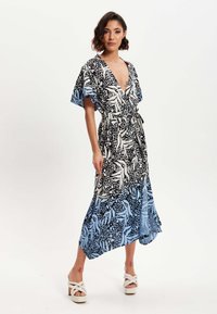 Floral wrap dress with a v-neck, flutter sleeves, and a mix of black and blue patterns. Features a tie waist and a flowing hemline.