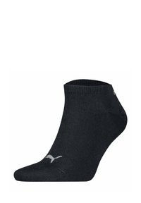 Chaussette noire à la cheville en matière lisse et extensible. Présente un bord côtelé et un petit logo blanc sur le côté.