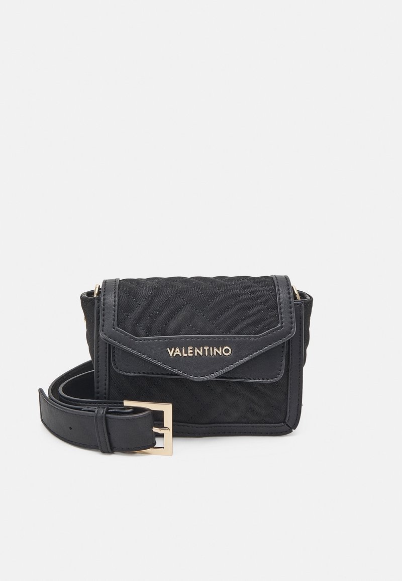 Black quilted fabric crossbody bag with a fold-over flap, gold hardware, and adjustable strap. Features the brand name "Valentino" embossed on the front.