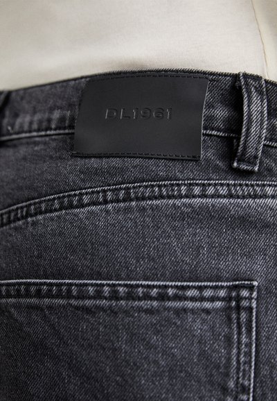 Black denim pants with a soft texture and subtle whiskering. Includes a leather label embossed with "DL1961" at the waistband.