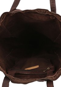 Brown leather tote bag with a zip closure, open interior, and a small zip pocket on one side, featuring textured material and sturdy straps.