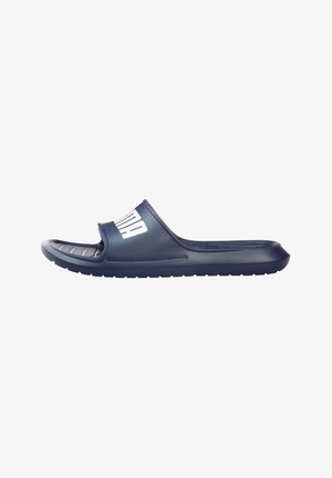 Navy blue slide sandal with a textured footbed and a wide strap featuring a prominent white logo. Made from durable plastic material.